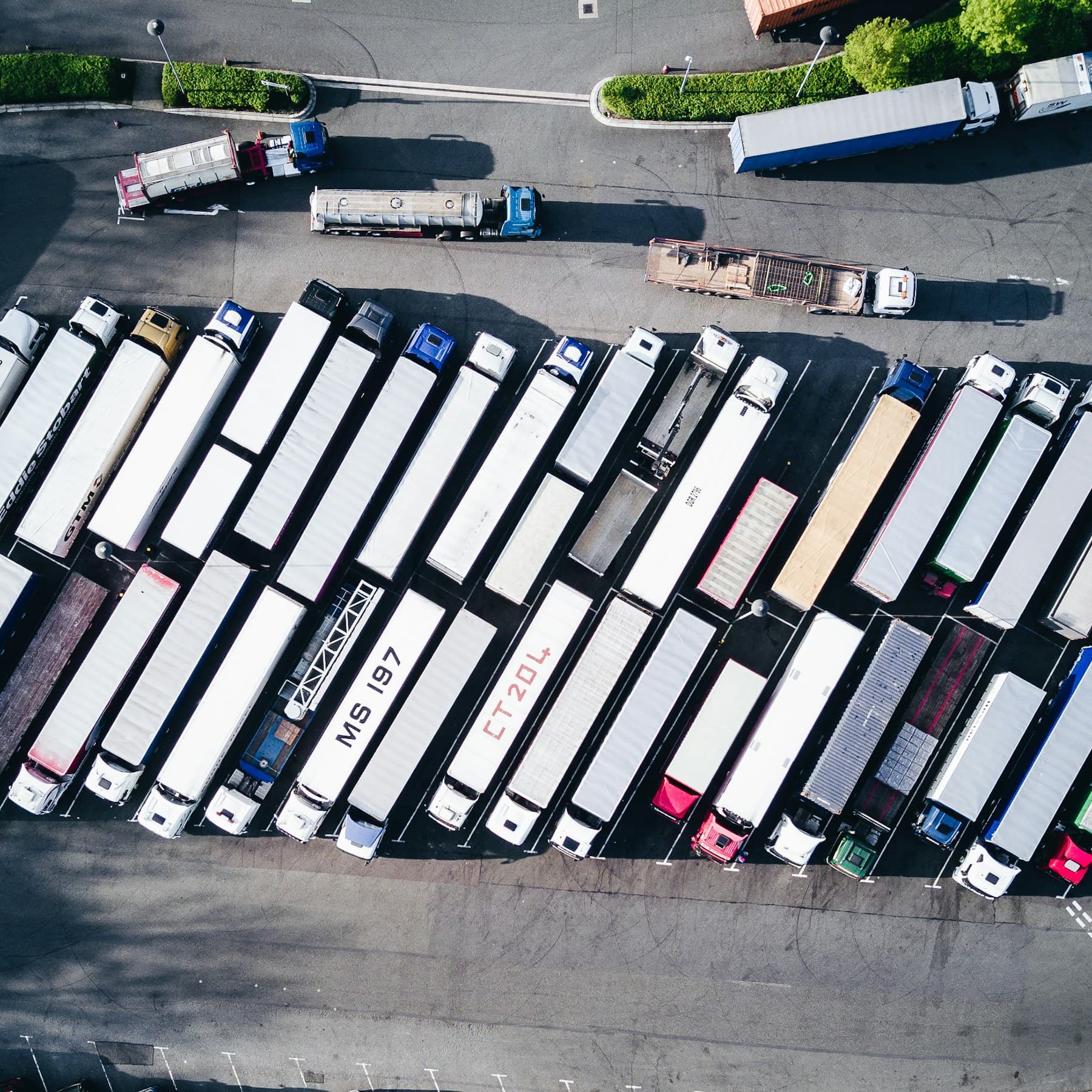 Aerial view of dozens of trailers staged in rows across a freight yard.